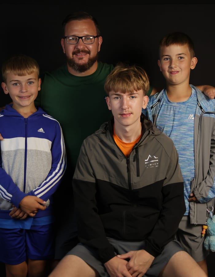 Father with three young sons — family portrait